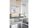 Close-up of a kitchen sink featuring modern fixtures and cabinetry with outdoor views at 2600 S Sherman St, Denver, CO 80210