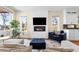 Cozy living room featuring a modern fireplace, large windows, and stylish furniture at 2600 S Sherman St, Denver, CO 80210