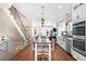 Spacious living area with a modern staircase, open floor plan, and stainless steel appliances at 2600 S Sherman St, Denver, CO 80210
