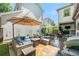 Backyard with stone patio, outdoor seating and dining, and mature landscaping at 3357 N Akron Ct, Denver, CO 80238