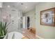 Bathroom with sleek glass shower, view to closet, and art detail at 3357 N Akron Ct, Denver, CO 80238