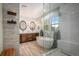 Bright primary bathroom boasts a soaking tub and walk-in shower at 3357 N Akron Ct, Denver, CO 80238
