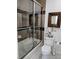 Well-lit bathroom with glass-enclosed shower, toilet and decorative elements at 3357 N Akron Ct, Denver, CO 80238