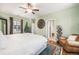 Bright bedroom featuring a comfortable bed, sitting chair, and decor at 3357 N Akron Ct, Denver, CO 80238