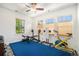 Bright exercise room is equipped with ceiling fan and multiple windows with window coverings at 3357 N Akron Ct, Denver, CO 80238