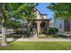 Attractive home featuring a stone-covered porch, lush landscaping, and a welcoming curb appeal at 3357 N Akron Ct, Denver, CO 80238