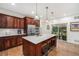 Stylish kitchen boasts dark wood cabinetry, stainless steel appliances, and a center island with barstool seating at 3357 N Akron Ct, Denver, CO 80238