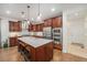 Well-equipped kitchen featuring custom cabinetry, stainless steel appliances, and a center island with seating at 3357 N Akron Ct, Denver, CO 80238