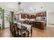 Gourmet kitchen and dining area with custom cabinets, stainless appliances, and hardwood floors at 3357 N Akron Ct, Denver, CO 80238