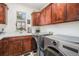 Well-equipped laundry room features updated machines, ample storage, and a functional sink area at 3357 N Akron Ct, Denver, CO 80238