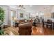 Open-concept living room with hardwood floors, a large sectional, and modern decor at 3357 N Akron Ct, Denver, CO 80238
