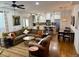 Open-concept living space connecting to the kitchen, featuring hardwood floors, a cozy couch, and natural light at 3357 N Akron Ct, Denver, CO 80238