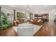 Bright and inviting living room featuring comfortable seating, large windows, and an open layout to the kitchen at 3357 N Akron Ct, Denver, CO 80238