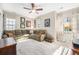 Spacious living room with a large sectional sofa, plush carpet, and abundant natural light at 3357 N Akron Ct, Denver, CO 80238