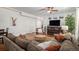 Spacious living room featuring hardwood floors, a cozy sectional, and ample natural light at 3357 N Akron Ct, Denver, CO 80238