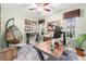 Stylish home office with modern furniture, a hanging chair, and bright window at 3357 N Akron Ct, Denver, CO 80238