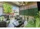 Covered back patio with seating, ceiling fan, and privacy elements at 3357 N Akron Ct, Denver, CO 80238