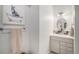Charming powder room with stylish vanity, brushed nickel fixtures, and unique artwork at 3357 N Akron Ct, Denver, CO 80238