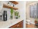 Stylish powder room featuring floating wood shelves, plants, and a modern aesthetic at 3357 N Akron Ct, Denver, CO 80238
