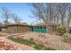 A landscaped backyard featuring a rock garden with brick borders, stepping stones, and wood fencing at 8511 Essex Dr, Denver, CO 80229