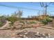 Landscaped backyard featuring natural rock garden with brick borders, stepping stones, and a wood fence at 8511 Essex Dr, Denver, CO 80229