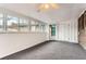 Finished basement featuring carpeted floors, large windows, and access to the outdoors at 8511 Essex Dr, Denver, CO 80229