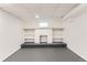 Basement featuring a unique white brick fireplace with built-in shelves and carpeted bench at 8511 Essex Dr, Denver, CO 80229
