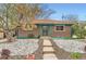 Charming brick home with a rock front yard and a welcoming, covered entryway at 8511 Essex Dr, Denver, CO 80229