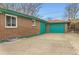 Exterior of home featuring a detached garage and a brick facade at 8511 Essex Dr, Denver, CO 80229