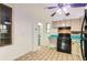 Functional kitchen featuring tile floors, vintage cabinetry, and open layout at 8511 Essex Dr, Denver, CO 80229