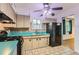Cozy kitchen featuring sleek appliances, vintage cabinets, and ample counter space at 8511 Essex Dr, Denver, CO 80229