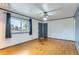 Bright living room featuring hardwood floors, fresh paint, and a ceiling fan at 8511 Essex Dr, Denver, CO 80229
