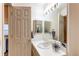 Well-lit half bathroom featuring a sink with vanity and mirrored wall cabinet at 1530 S Quebec Way # 29, Denver, CO 80231