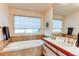 Inviting bathroom featuring a soaking tub, sleek vanity, and natural light, creating a relaxing retreat at 1530 S Quebec Way # 29, Denver, CO 80231