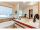 Bathroom showcasing a bathtub and vanity with a large mirror, designed for comfort and functionality at 1530 S Quebec Way # 29, Denver, CO 80231