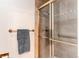 Tiled shower enclosure featuring glass doors and a bronze-toned towel rack at 1530 S Quebec Way # 29, Denver, CO 80231