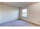 Neutral bedroom with a window providing natural light and a view, and wall-to-wall carpeting at 1530 S Quebec Way # 29, Denver, CO 80231