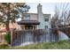 Two-story home featuring a red tile roof, stucco siding and a wood fence at 1530 S Quebec Way # 29, Denver, CO 80231