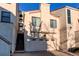 Two-story home featuring a garage, red tile roof, stucco siding and stairs to the main entrance at 1530 S Quebec Way # 29, Denver, CO 80231
