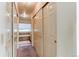 Hallway with ample closet space leading to a bathroom featuring a tub, offering convenience and storage at 1530 S Quebec Way # 29, Denver, CO 80231
