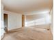 Bright living room with neutral carpeting and trim, showcasing ample space and natural light at 1530 S Quebec Way # 29, Denver, CO 80231