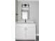 Bathroom featuring a white vanity cabinet with a black faucet, a mirror, and modern lighting at 1543 Glencoe St, Denver, CO 80220