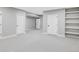 Spacious bedroom featuring neutral carpet and built-in shelves for extra storage at 1543 Glencoe St, Denver, CO 80220