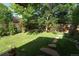 Lush green backyard with mature trees and stone pathways, perfect for outdoor enjoyment at 919 Taylor Ln, Erie, CO 80516
