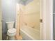 Well-lit bathroom featuring a combined shower and bathtub with light-colored tiles and blue wall at 919 Taylor Ln, Erie, CO 80516