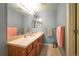 Bathroom featuring double sinks, wood cabinets and tile flooring at 919 Taylor Ln, Erie, CO 80516