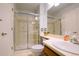 Well-lit bathroom features a glass-enclosed shower, a white sink, and modern fixtures for a clean design at 919 Taylor Ln, Erie, CO 80516