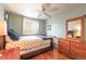 Comfortable bedroom with hardwood floors, a large window, and blue accents at 919 Taylor Ln, Erie, CO 80516