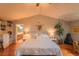 Tranquil bedroom with a vaulted ceiling, hardwood floors, neutral decor, and an ensuite bathroom at 919 Taylor Ln, Erie, CO 80516