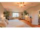 Relaxing bedroom featuring hardwood floors, a comfortable seating area, and natural light at 919 Taylor Ln, Erie, CO 80516